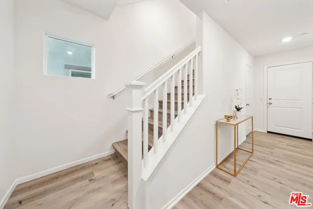 a view of entryway with wooden floor and stairs