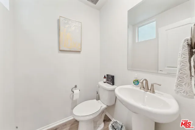 a bathroom with a sink toilet and a mirror