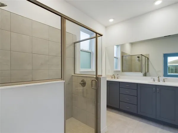 a bathroom with a double vanity sink and mirror