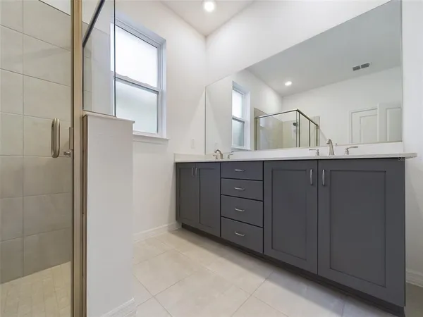 a bathroom with a double vanity sink and mirror