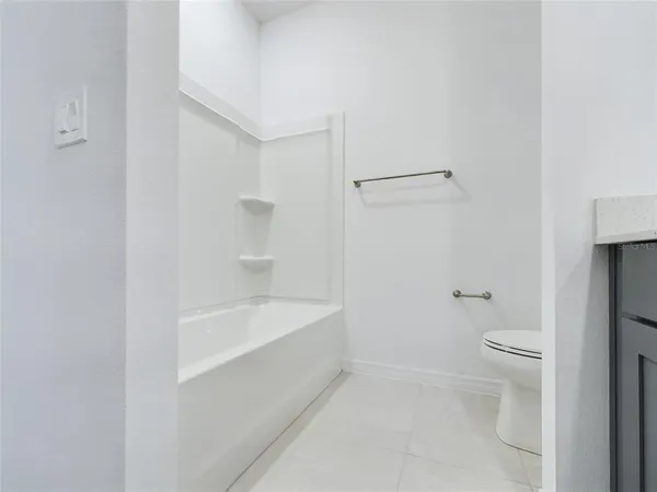 a bathroom with a bathtub and a toilet