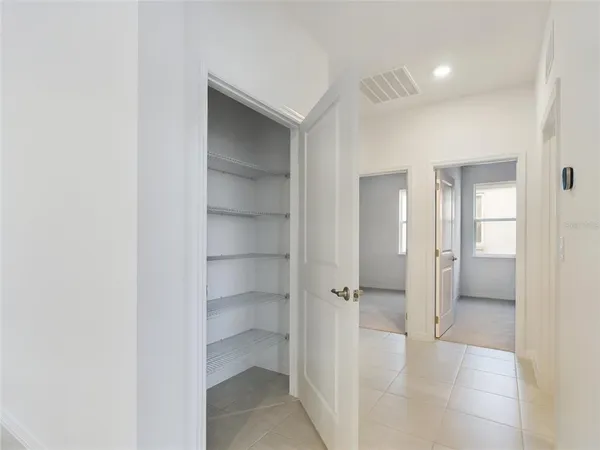 a view of a walk in closet and a living room