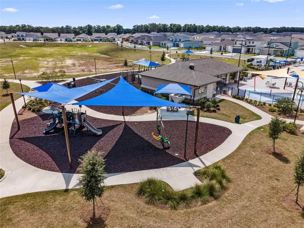an aerial view of a house with outdoor seating space