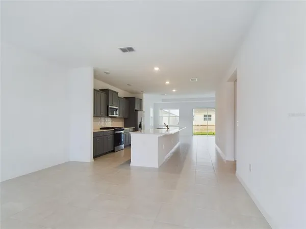 a view of a kitchen with a sink and cabinets