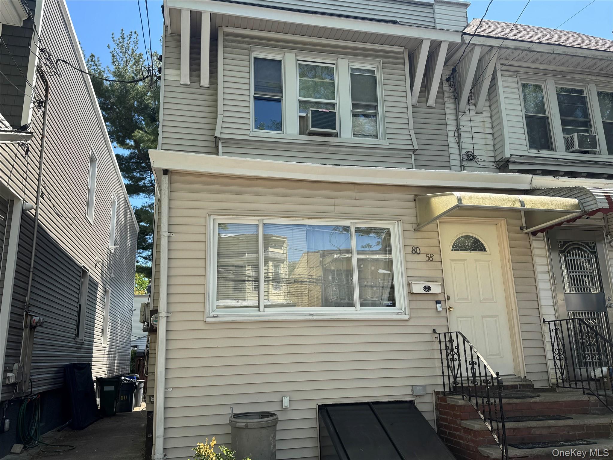 80-58 88th Road Queens, NY 11421 - Photo 2 of 21 a front view of a house with a porch