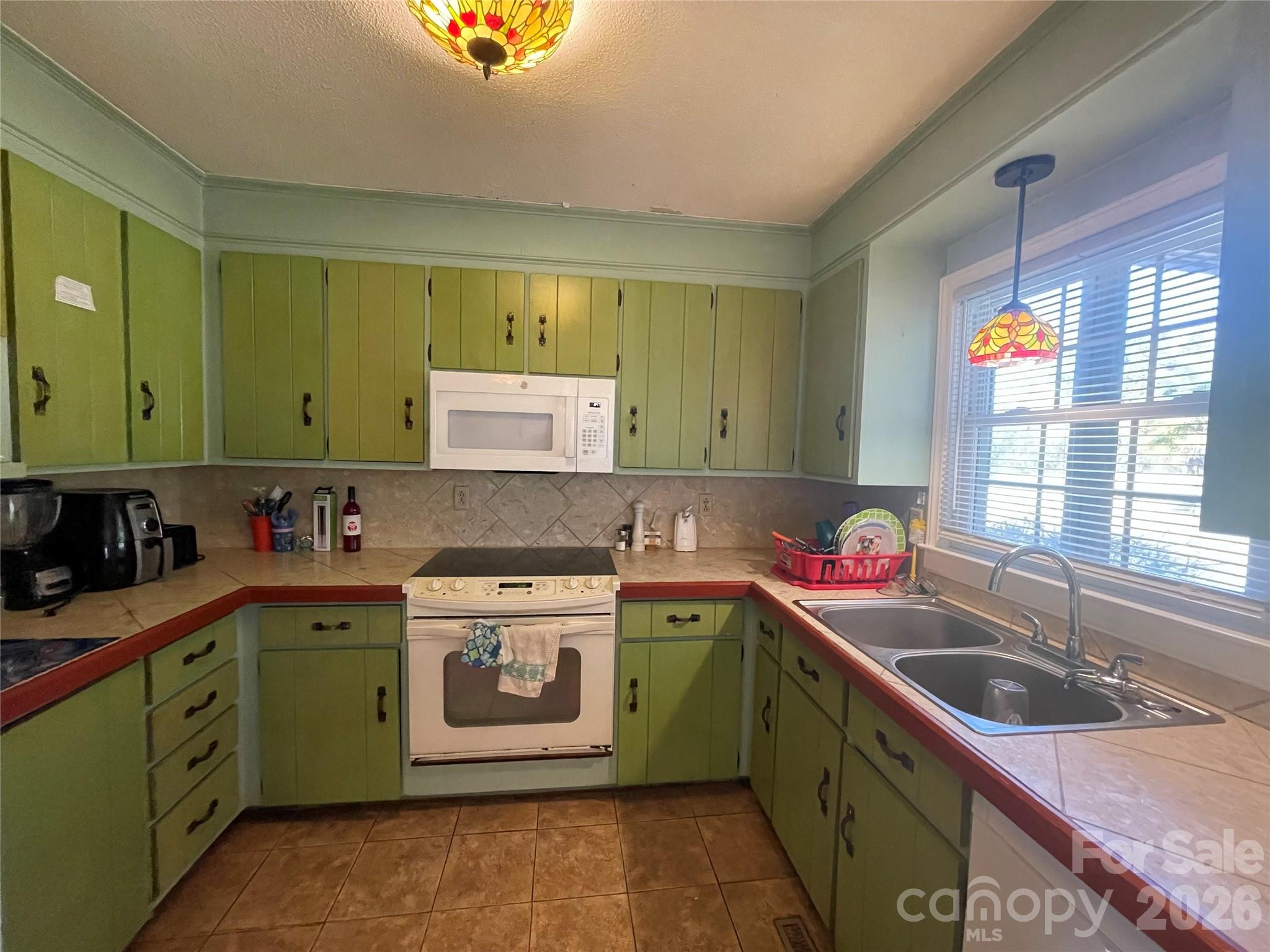 4907 Delmar Griffin Road Monroe, NC 28112 - Photo 7 of 25 a kitchen with a sink and a stove top oven