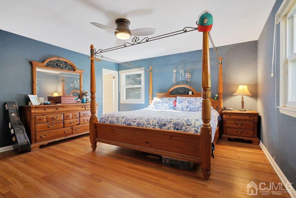 1 Wallace Road Middletown, NJ 07748 - Photo 12 of 28 a bedroom with a bed and wooden floor