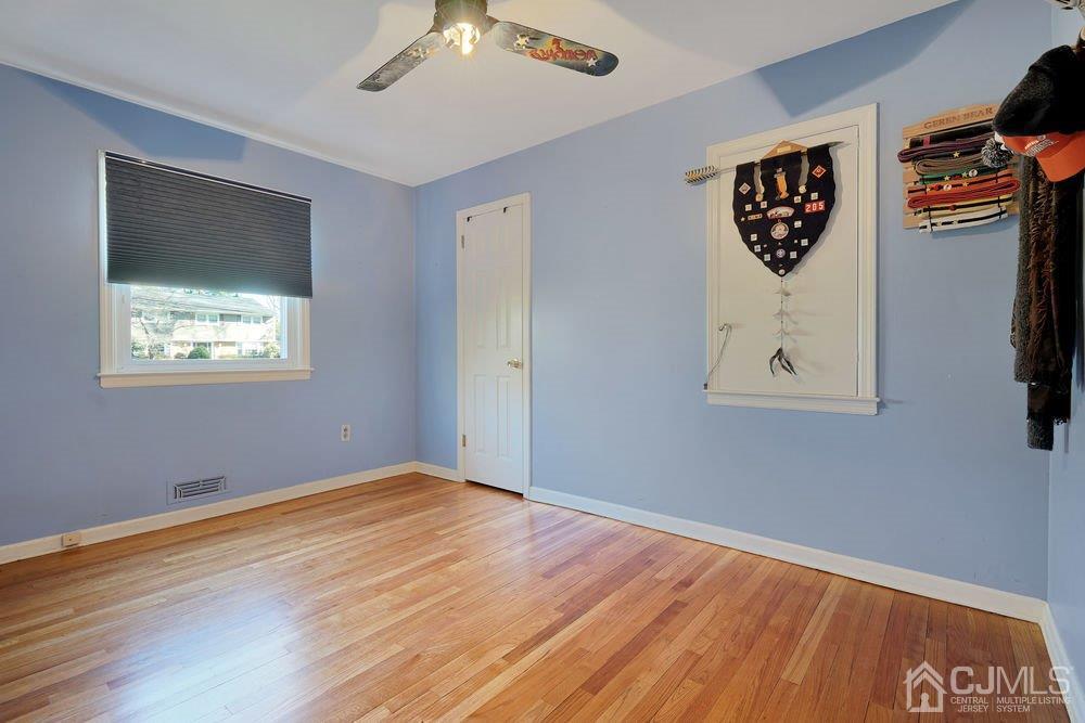 1 Wallace Road Middletown, NJ 07748 - Photo 15 of 28 a view of an empty room with wooden floor and a window
