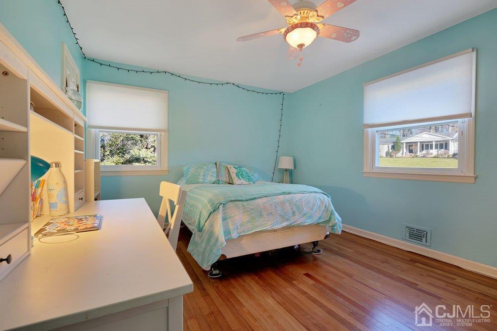 1 Wallace Road Middletown, NJ 07748 - Photo 16 of 28 a bedroom with a bed and a chandelier