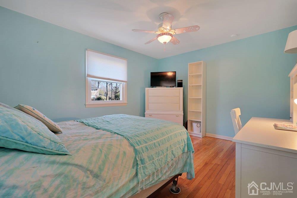 1 Wallace Road Middletown, NJ 07748 - Photo 17 of 28 a bedroom with a bed and a chandelier
