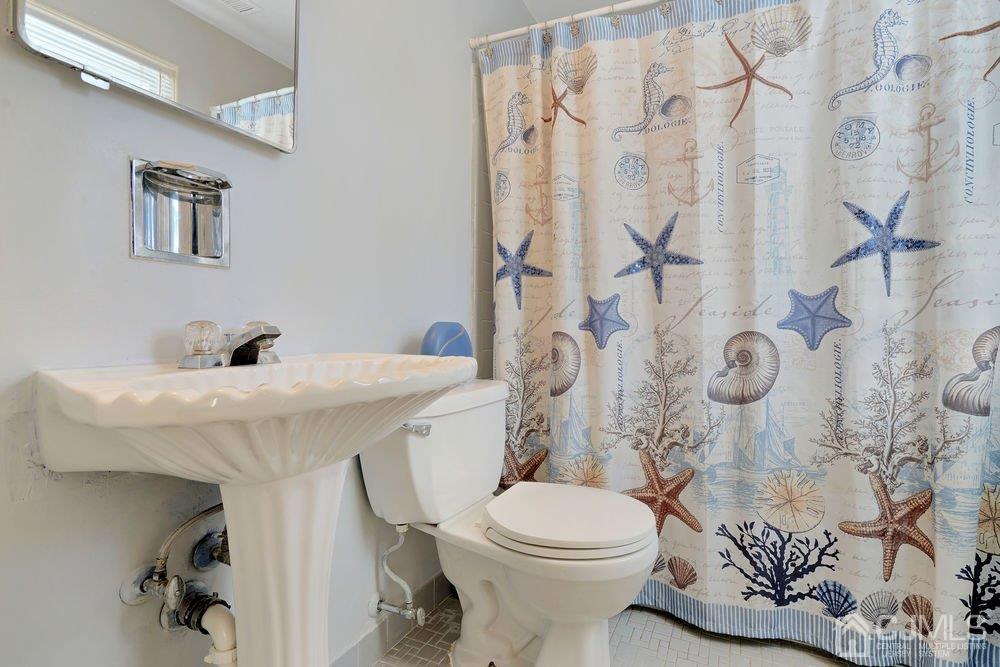 1 Wallace Road Middletown, NJ 07748 - Photo 22 of 28 a bathroom with a sink toilet and shower