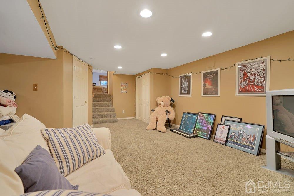 1 Wallace Road Middletown, NJ 07748 - Photo 23 of 28 a spacious bedroom with a bed and a couch