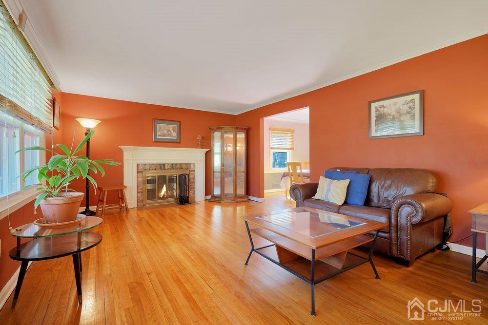 1 Wallace Road Middletown, NJ 07748 - Photo 6 of 28 a living room with furniture a fireplace and a potted plant