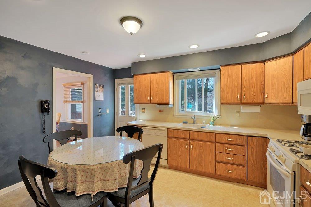 1 Wallace Road Middletown, NJ 07748 - Photo 9 of 28 a kitchen with a table chairs sink and cabinets