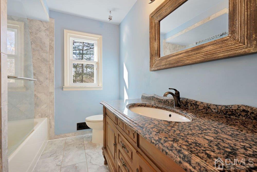 1 Wallace Road Middletown, NJ 07748 - Photo 10 of 28 a bathroom with a sink and a bathtub
