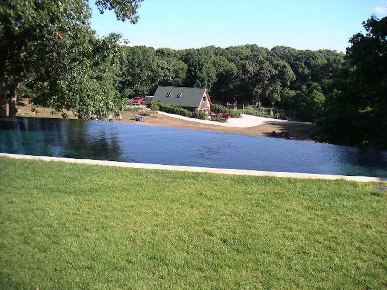 72 South Ferry Road Shelter Island, NY 11964 - Photo 13 of 26 a backyard of a house with lots of green space and lake view