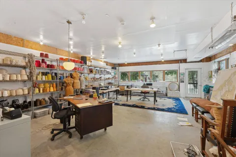 a living room with lots of furniture and a view of dining table