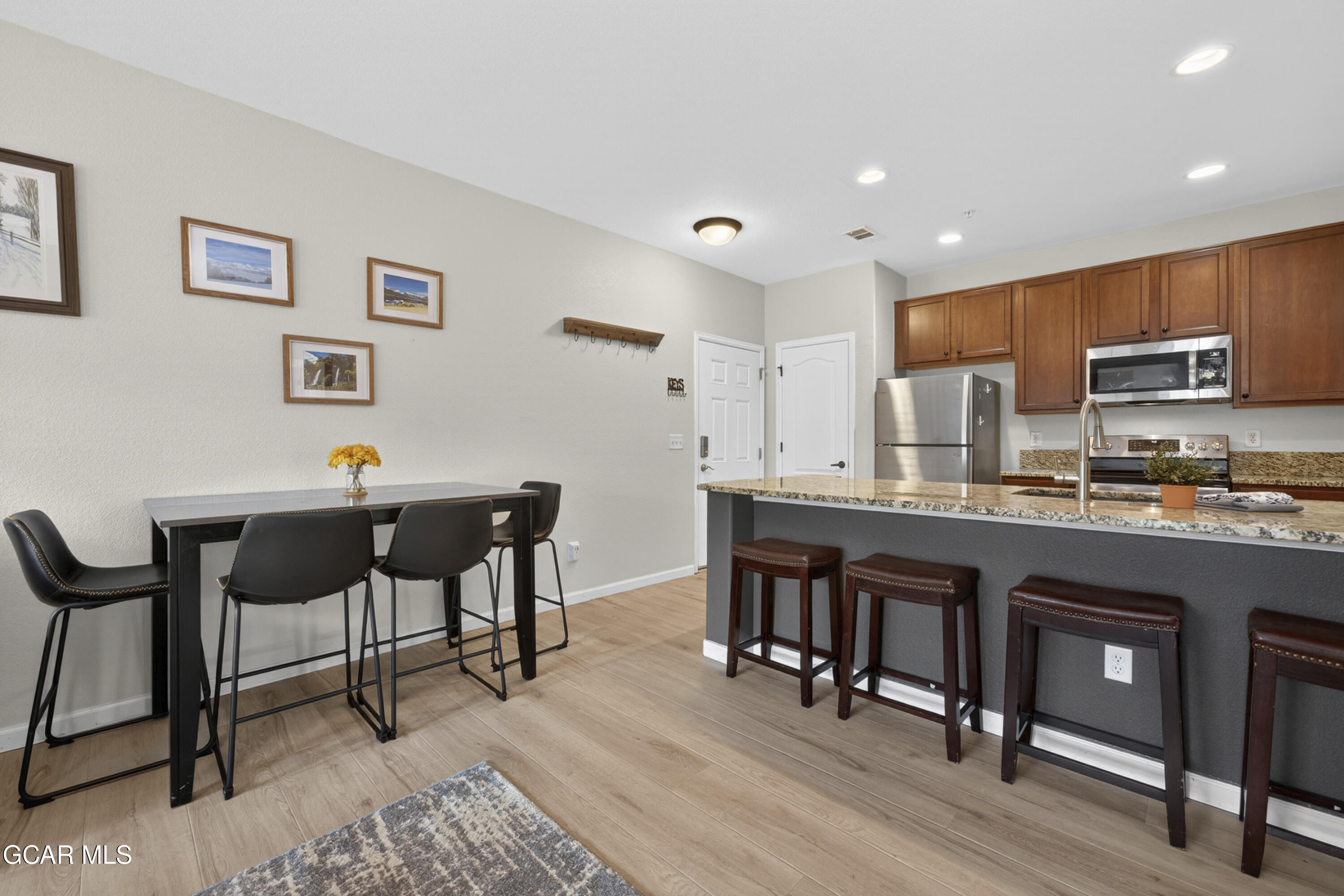 158 Village Road Granby, CO 80446 - Photo 9 of 46 a open kitchen with stainless steel appliances granite countertop a table and chairs in it