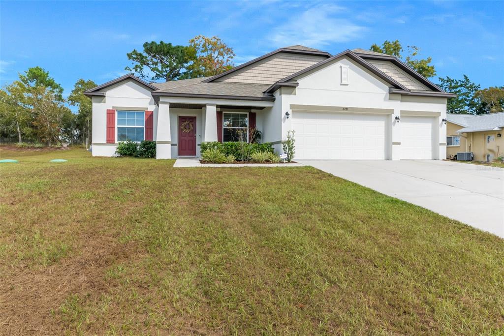 6283 Grapewood Road Spring Hill, FL 34609 - Photo 1 of 41 a front view of a house with yard