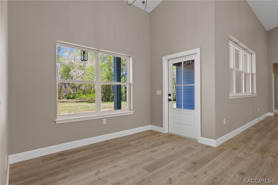 4530 South Florida Avenue Inverness, FL 34450 - Photo 15 of 100 a view of an empty room with wooden floor and windows