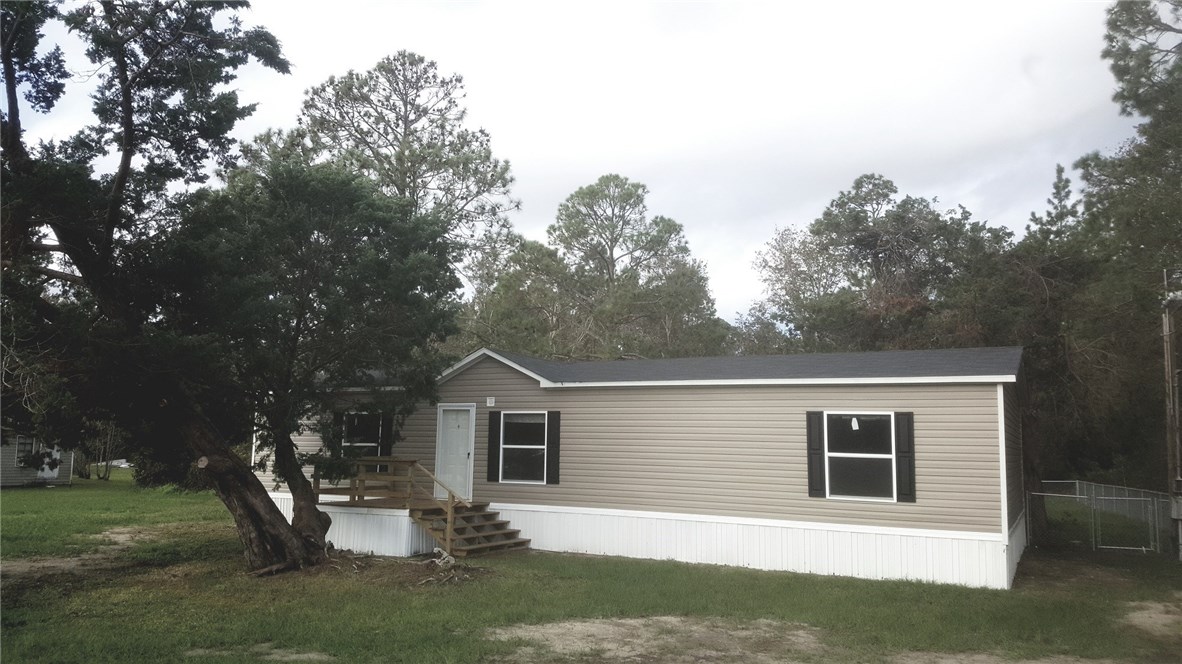 96311 Blackrock Road Yulee, FL 32097 - Photo 1 of 8 a front view of a house with a yard