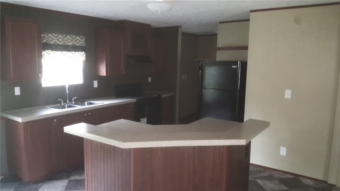96311 Blackrock Road Yulee, FL 32097 - Photo 4 of 8 a kitchen with a sink a refrigerator and window