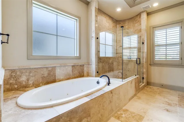 a bathroom with a tub and shower