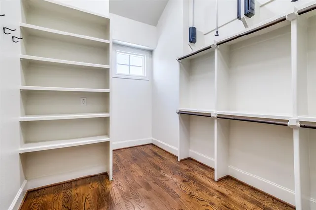 a view of walk in closet with empty racks