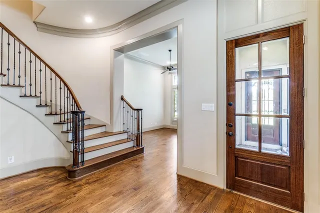 a view of entryway and hall with wooden floor