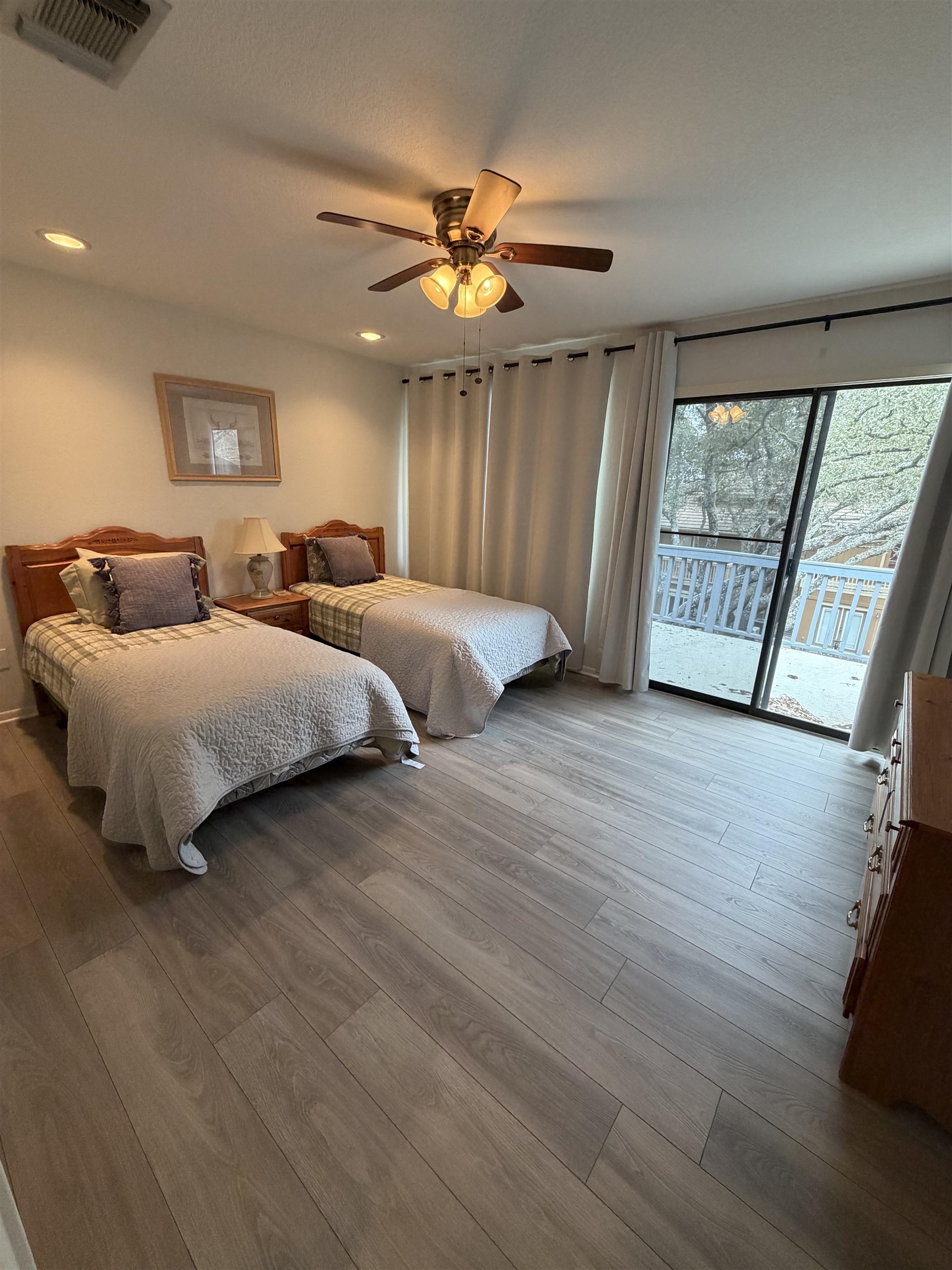 307 Crestview Horseshoe Bay, TX 78657 - Photo 11 of 24 a bedroom with two beds and a large window