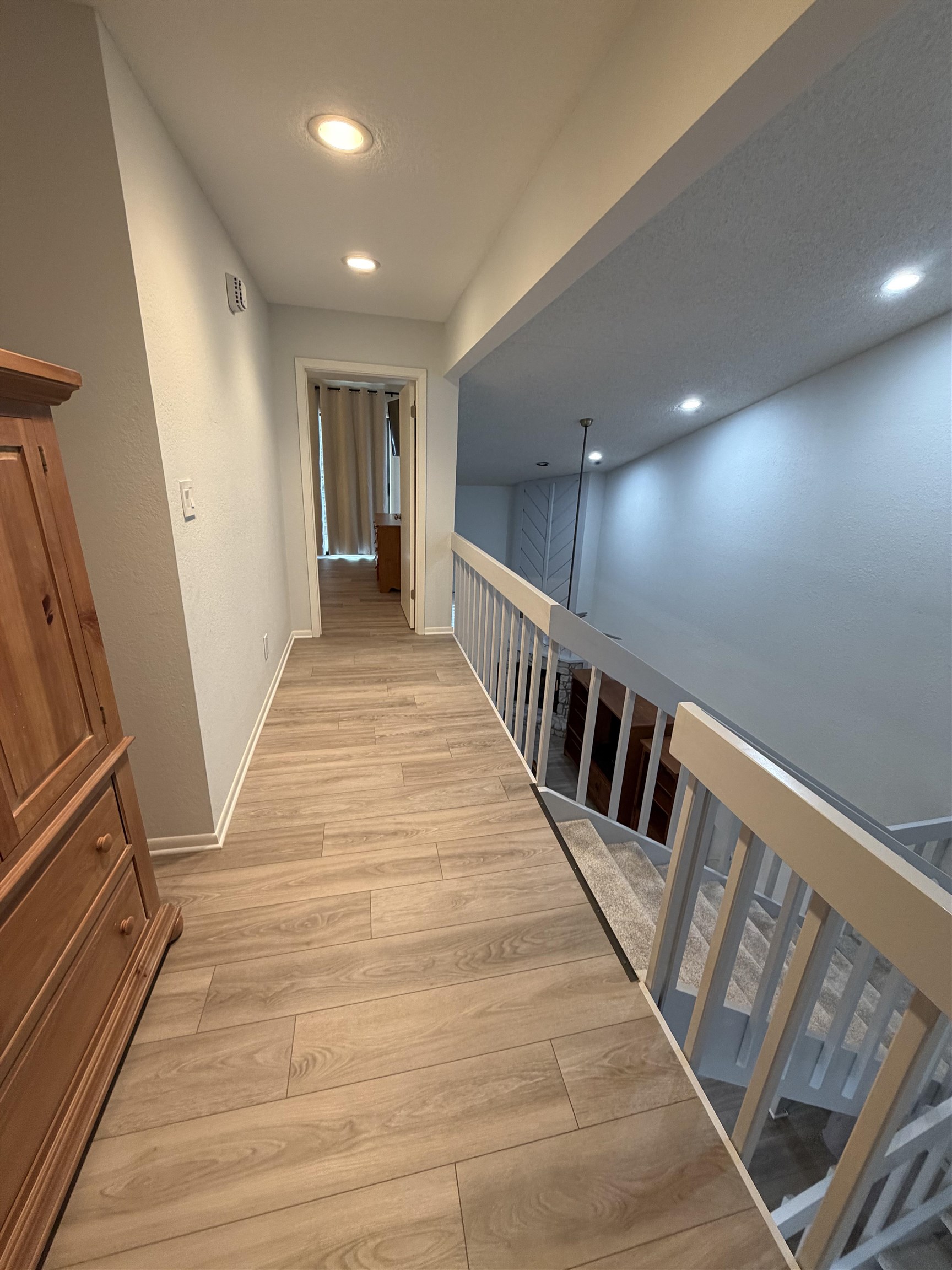 307 Crestview Horseshoe Bay, TX 78657 - Photo 14 of 24 a view of a hallway with wooden floor and stairs