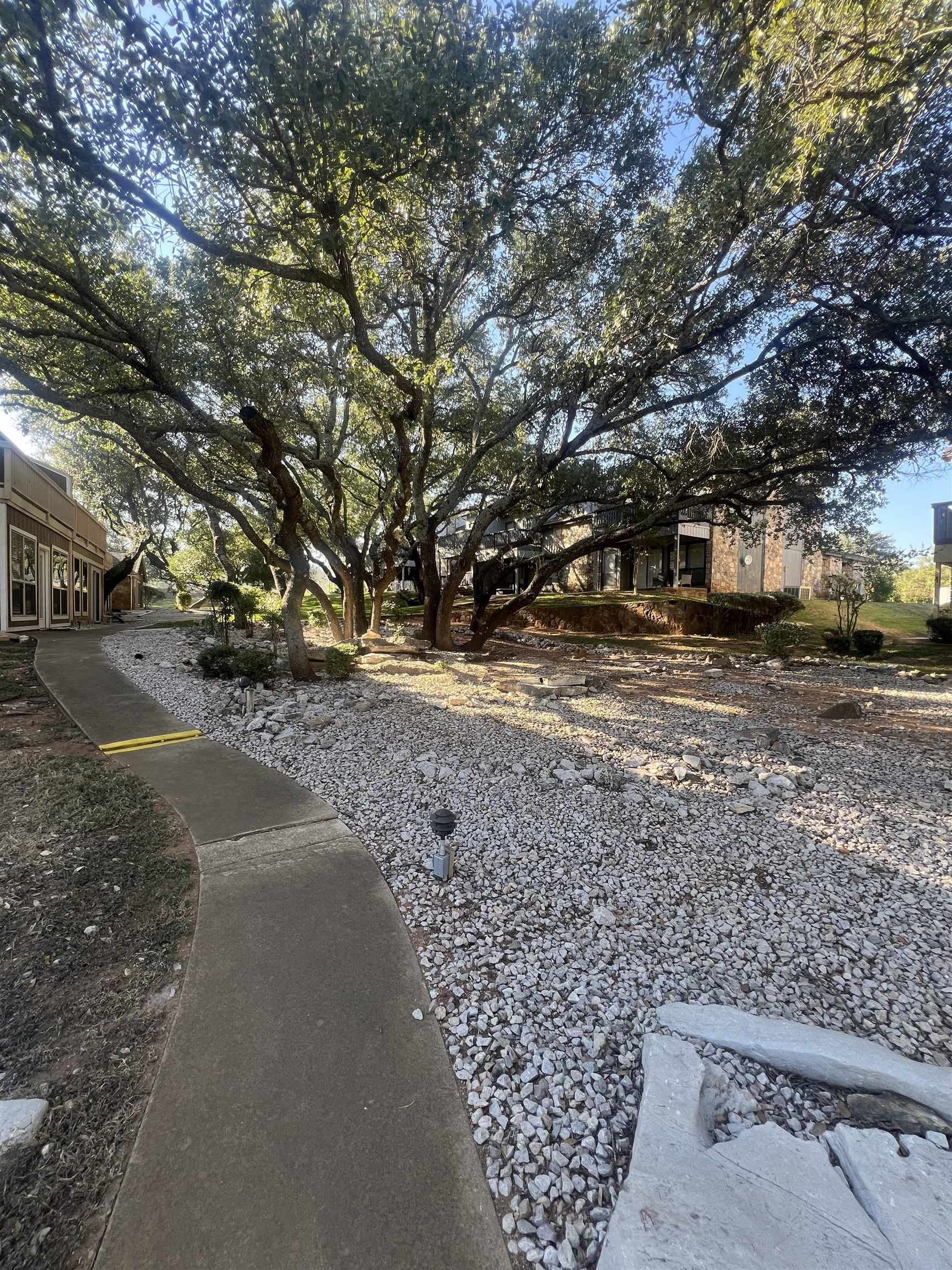 307 Crestview Horseshoe Bay, TX 78657 - Photo 20 of 24 a view of a yard with plants and trees