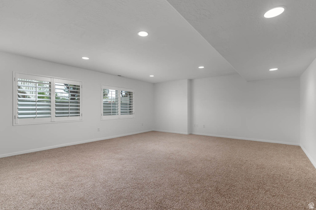 439 East 13540 South Draper, UT 84020 - Photo 26 of 46 Spacious room featuring neutral carpeting, recessed lighting, and two windows with white louvered shutters