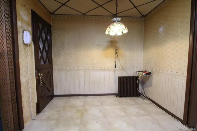 an empty room with windows and cabinet