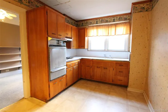 a kitchen with sink cabinets and window