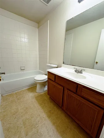 a bathroom with a double vanity sink toilet and shower