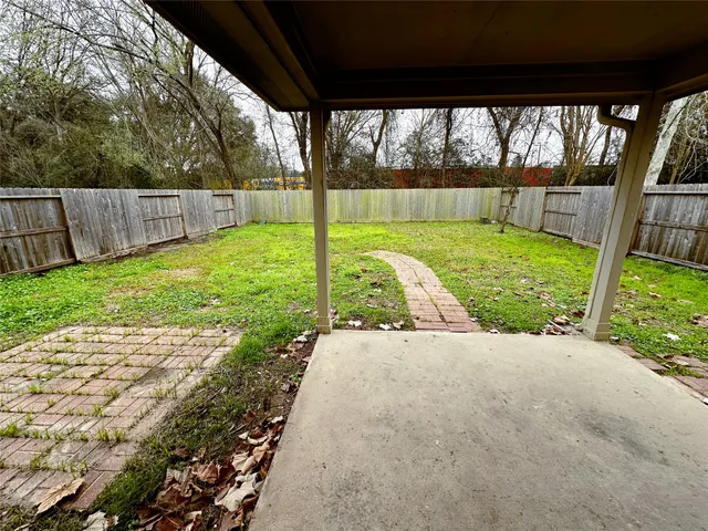 a view of a backyard with barn and large trees