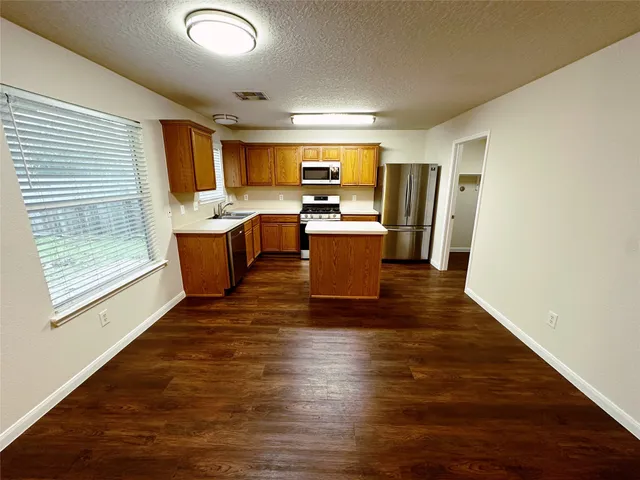 a view of kitchen with sink and microwave