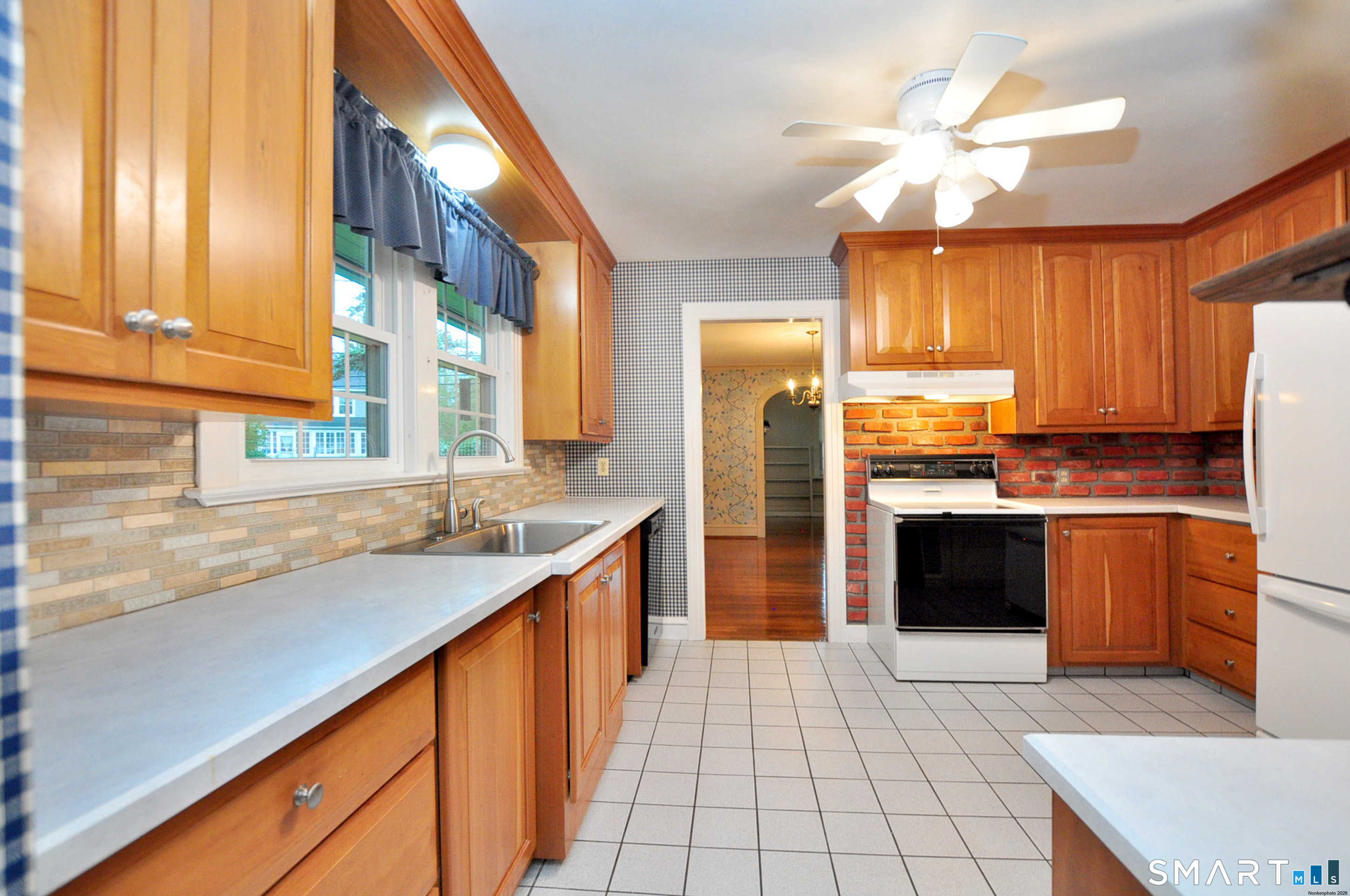 10 Harvey Road Windsor, CT 06095 - Photo 13 of 36 a kitchen with stainless steel appliances granite countertop a sink a stove cabinets counter space and a window
