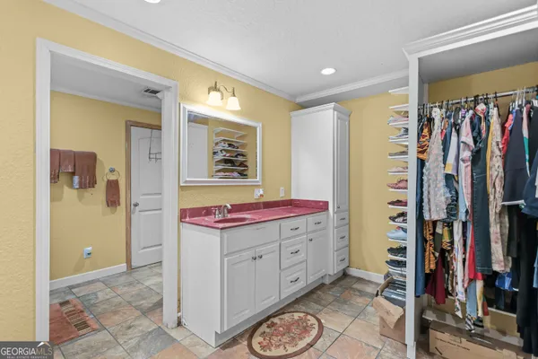 a view of a bedroom with closet and furniture