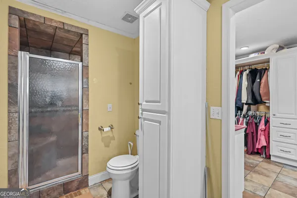 a bathroom with a shower and a toilet