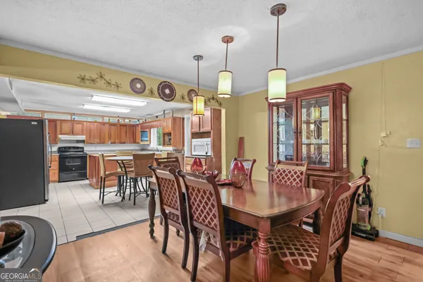 a view of a a dining room with furniture window and wooden floor