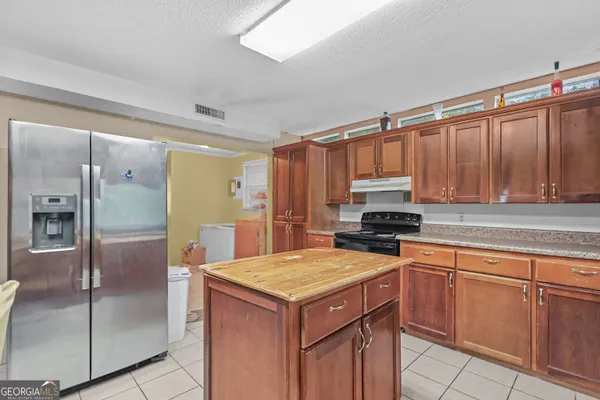 a kitchen with a stove a sink and a refrigerator