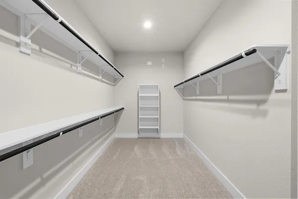 a view of walk in closet with empty racks