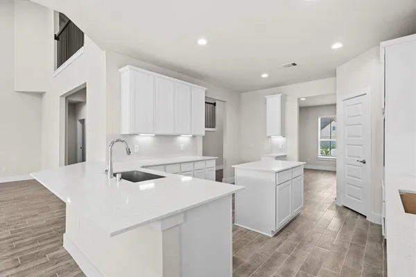 a kitchen with a sink appliances and cabinets