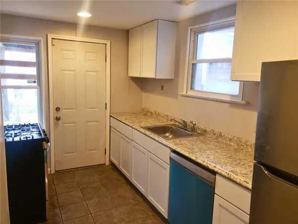 a kitchen with a refrigerator stove and sink
