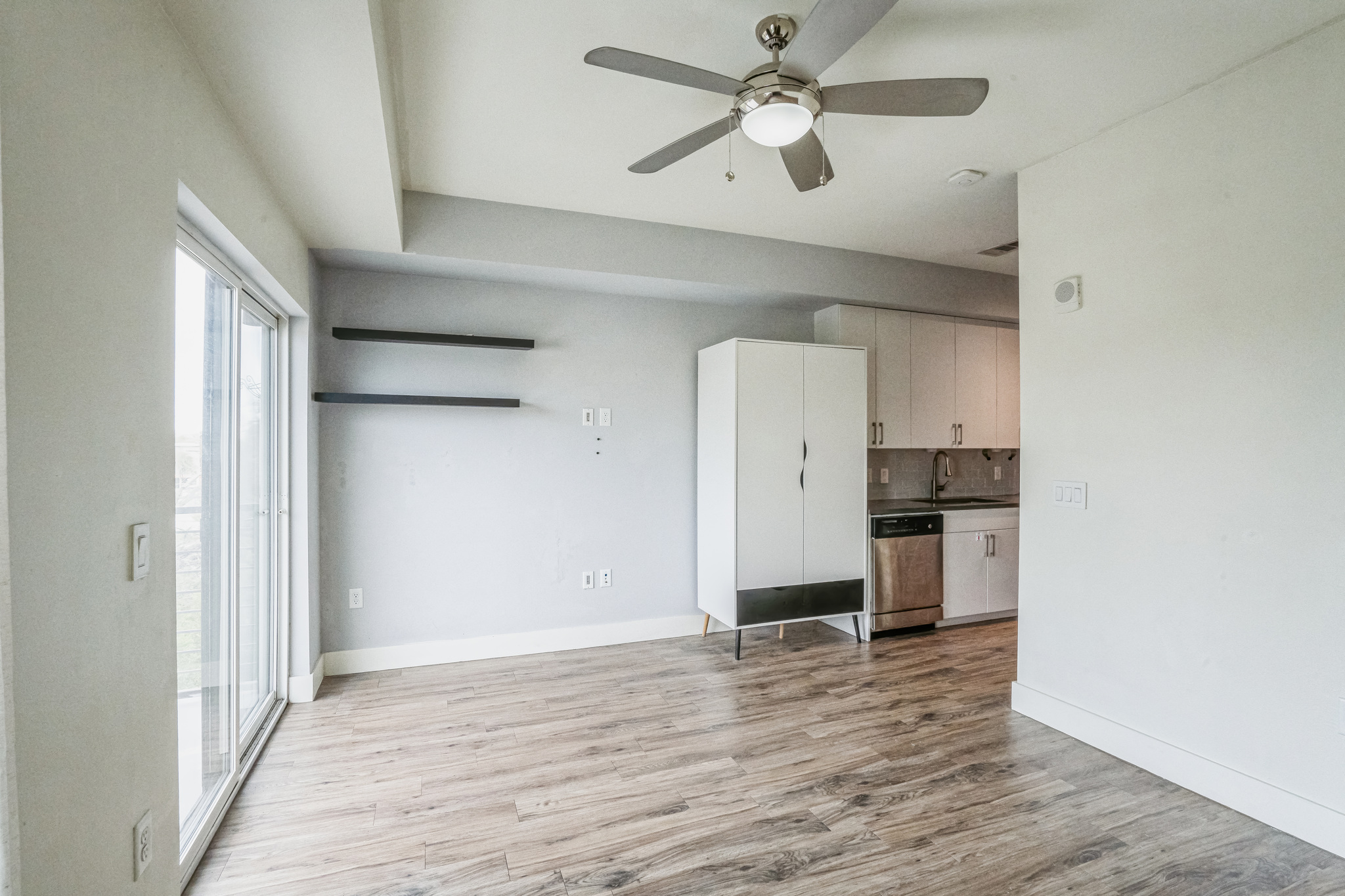 6444 Burnet Road, Unit 305 Austin, TX 78757 - Photo 4 of 13 a view of a room with wooden floor and a ceiling fan