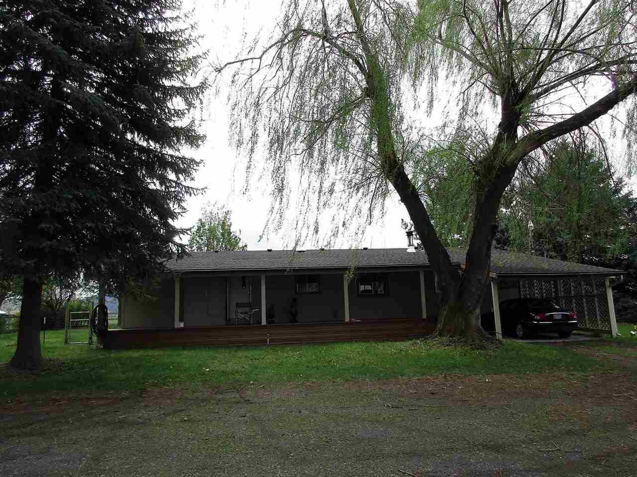 10901 Crystal Springs Road Klamath Falls, OR 97603 - Photo 19 of 21 a front view of a house with a garden and trees