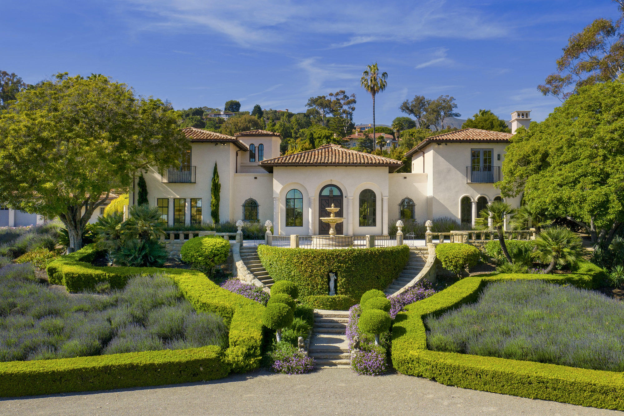 a front view of a house with swimming pool and sitting area