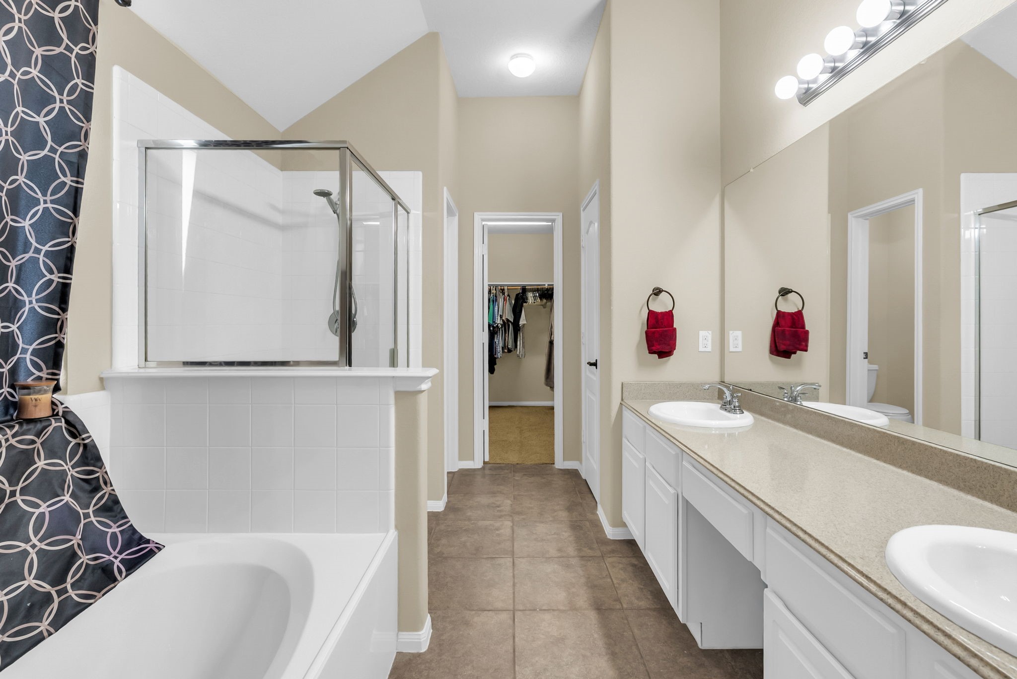 16619 Dover Mills Drive Spring, TX 77379 - Photo 28 of 49 a bathroom with a tub a sink and a large mirror